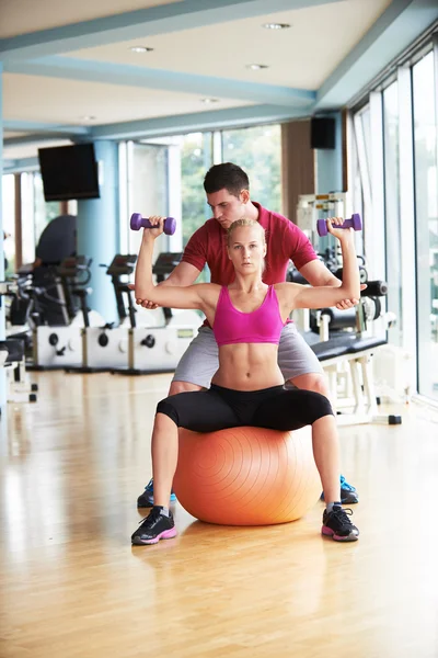 Woman with trainer exercise weights lifting — Stock Photo, Image