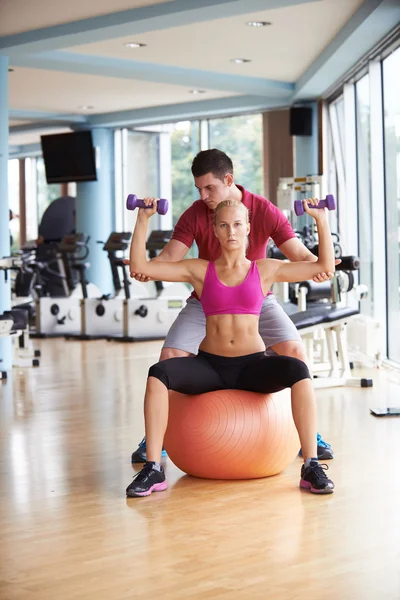 Woman with trainer exercise weights lifting — Stock Photo, Image