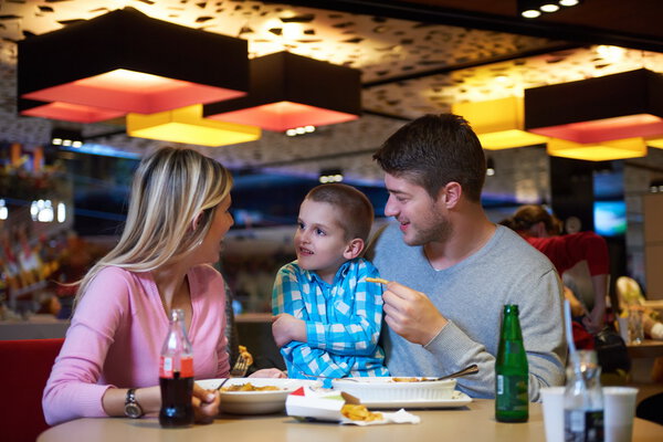 family having lunch in shopping mall