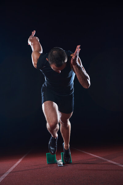 Sprinter leaving starting blocks