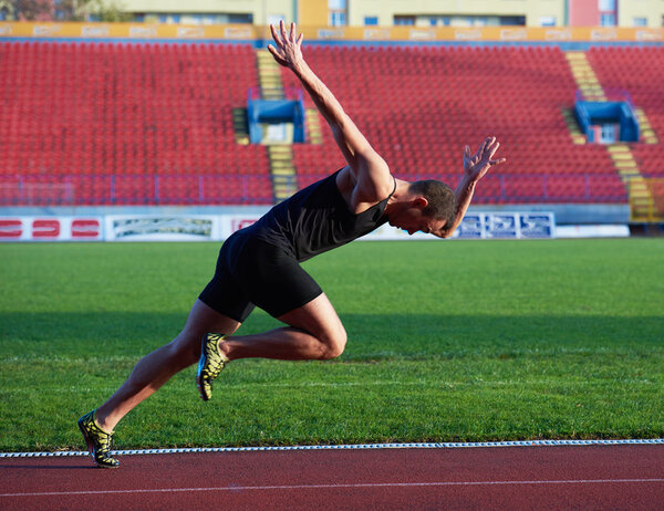 Athletic man start on track