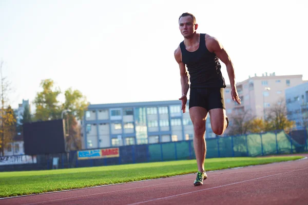 Athletic man start on track — Stock Photo, Image