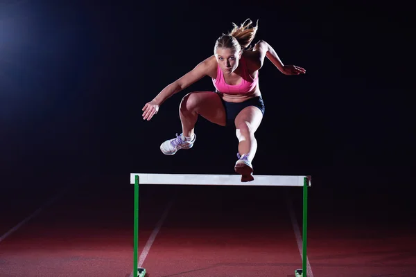 Woman athlete and hurdles — Stock Photo, Image