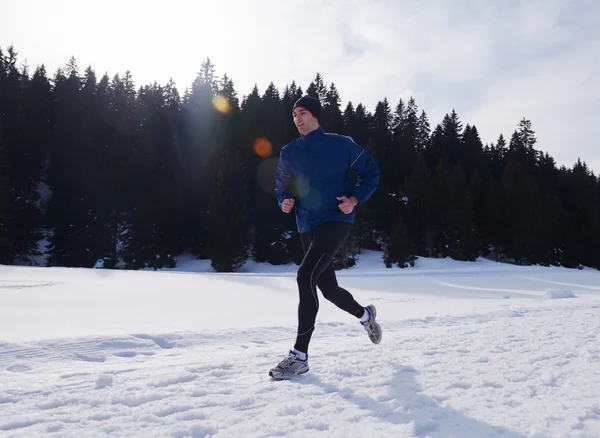 Jogging on snow in forest — Stock Photo, Image