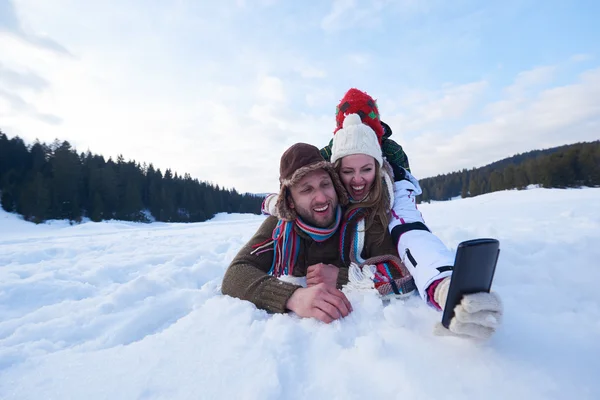 Family having fun in fresh snow and taking selfie — 图库照片