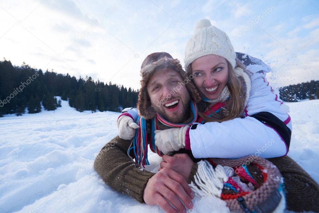 romantic couple having fun in fresh snow and taking selfie