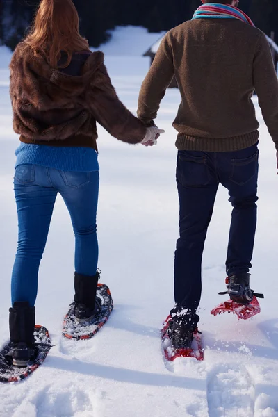 Pareja divirtiéndose en zapatos de nieve —  Fotos de Stock