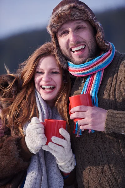 Happy young couple drinking warm tea at winter — Stock Photo, Image