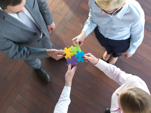 Business people group assembling jigsaw puzzle — Stock Photo, Image