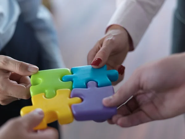 Business people group assembling jigsaw puzzle — Stock Photo, Image