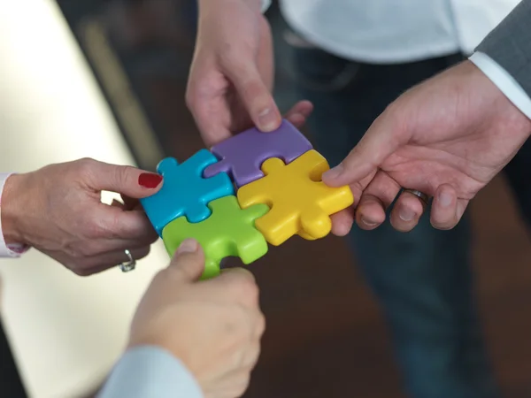 Business people group assembling jigsaw puzzle — Stock Photo, Image