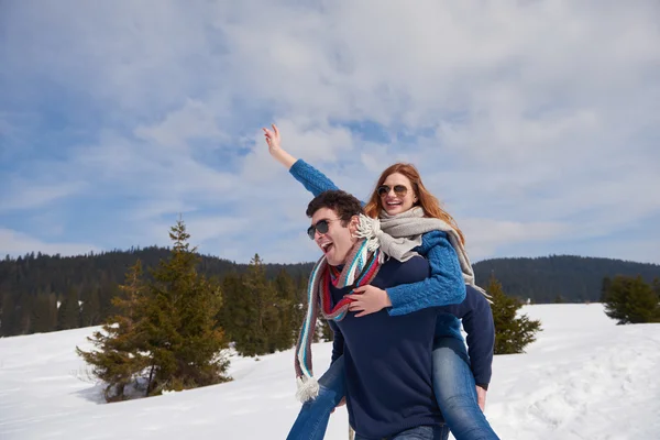 Couple having fun on fresh show on winter vacation — Stock Photo, Image