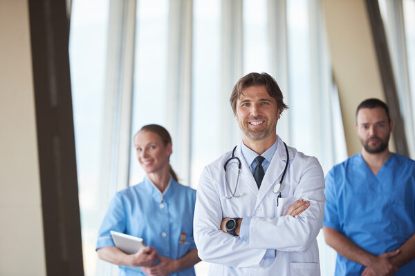 group of medical staff at hospital, handsome doctor in front