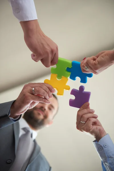 Business people group assembling jigsaw puzzle — Stock Photo, Image