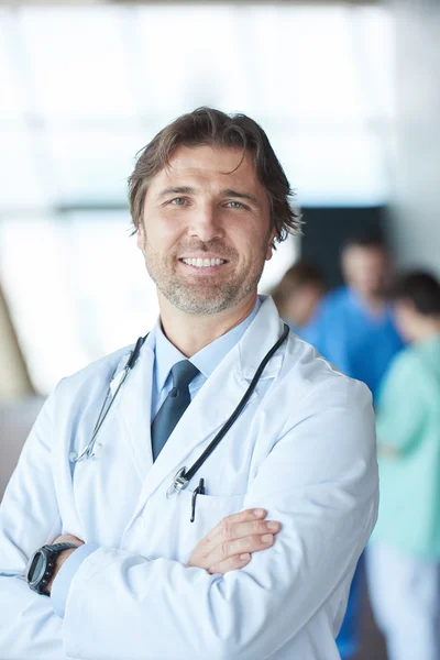 Handsome doctor in front of team — Stock Photo, Image