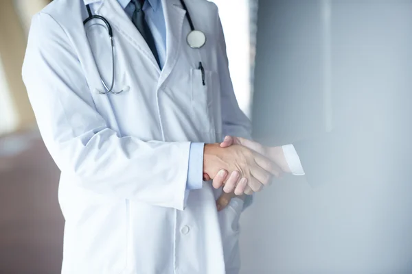 Doctor handshake with a patient — Stock Photo, Image