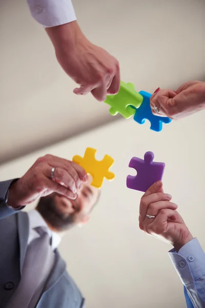 Business people group assembling jigsaw puzzle — Stock Photo, Image