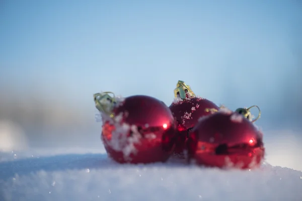 美しい晴れた冬の日に新鮮な雪の背景でクリスマスの赤いボールの装飾 — ストック写真