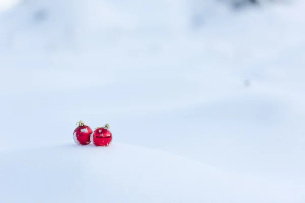 Red christmas balls in fresh snow — Stock Photo, Image