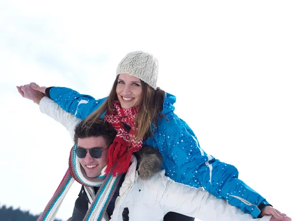 Couple having fun on fresh snow on winter vacation — Stock Photo, Image