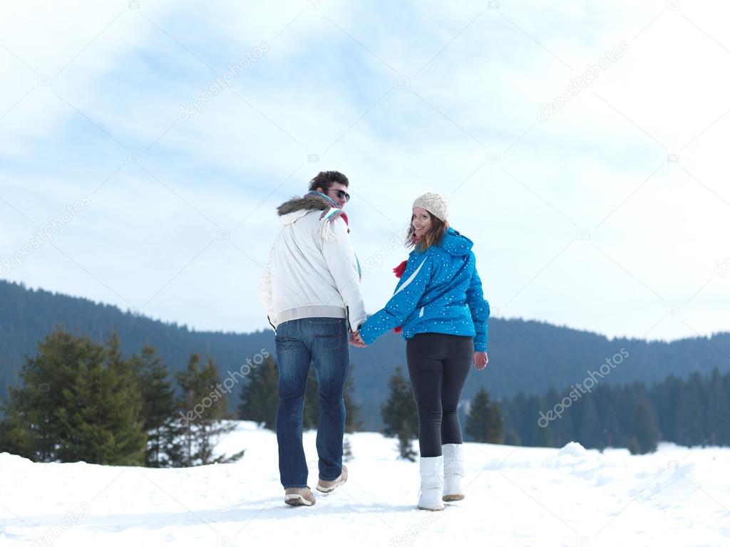 couple having fun on fresh snow on winter vacation