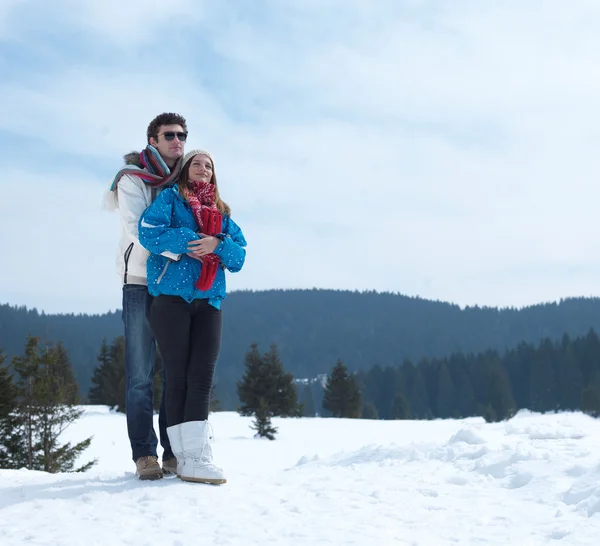 Couple having fun on fresh snow on winter vacation — Stock Photo, Image