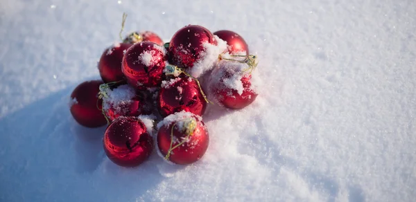 新鮮な雪の中の赤いクリスマス ボール — ストック写真