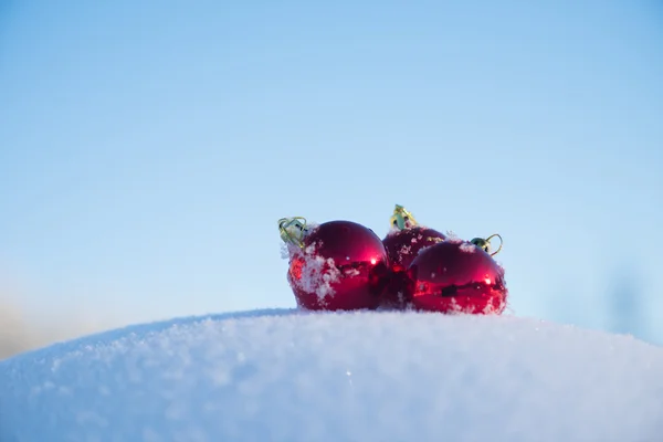 新鮮な雪の中の赤いクリスマス ボール — ストック写真