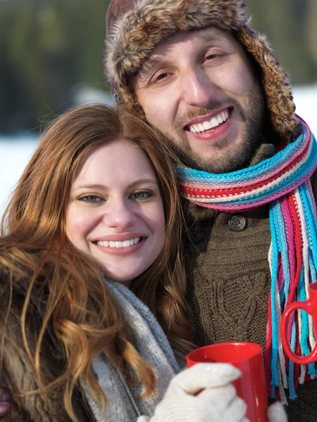 Feliz joven pareja bebiendo té caliente en invierno —  Fotos de Stock