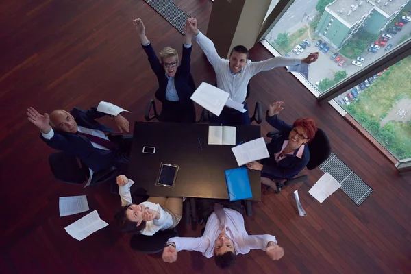 Top view of business people group throwing dociments in air — Stock Photo, Image