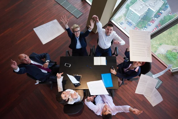 top view of business people group throwing dociments in air