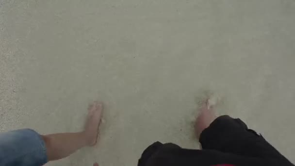 Mannen och kvinnans fötter perspektiv när hon gick på sandy — Stockvideo