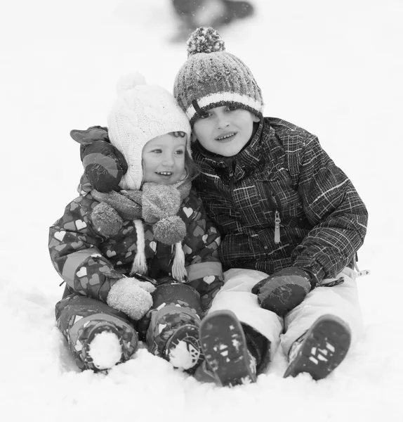 Kids having fun and play together in snow — Stock Photo, Image