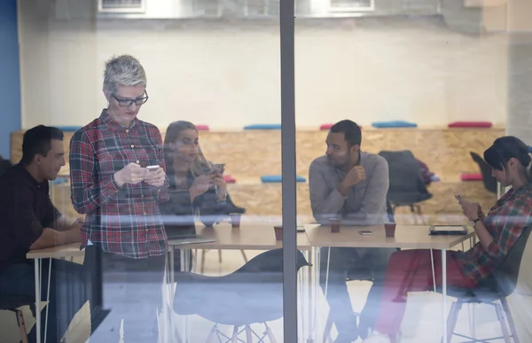 Business woman in meeting room  speaking by cell phone — Stock Photo, Image