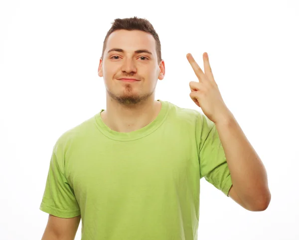 Young casual man showing the victory gesture — Stock Photo, Image