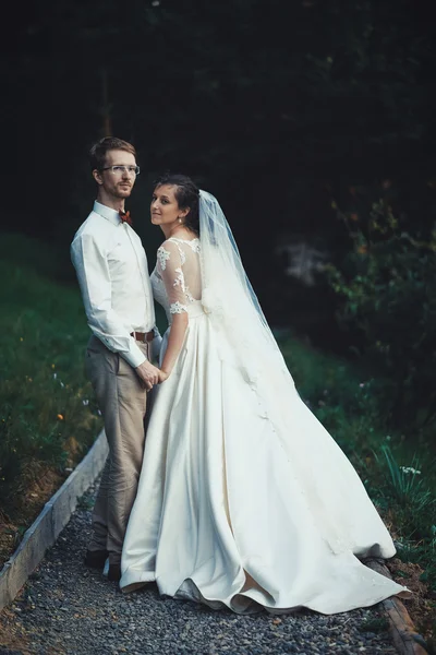 Una giovane sposa e lo sposo in piedi insieme all'aperto — Foto Stock