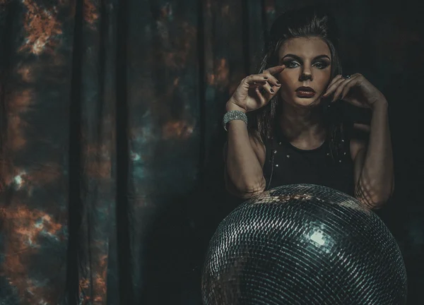 Beautiful young sensual woman holding disco ball — Stock Photo, Image