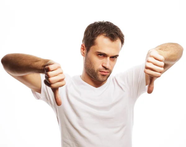 Young casual man making the thumbs down — Stock Photo, Image