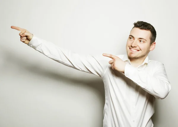 Business man points with fingers in the right side — Stock Photo, Image