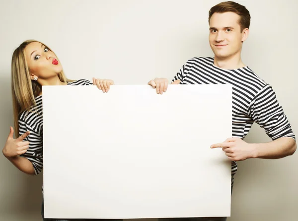 Couple holding a banner — Stock Photo, Image