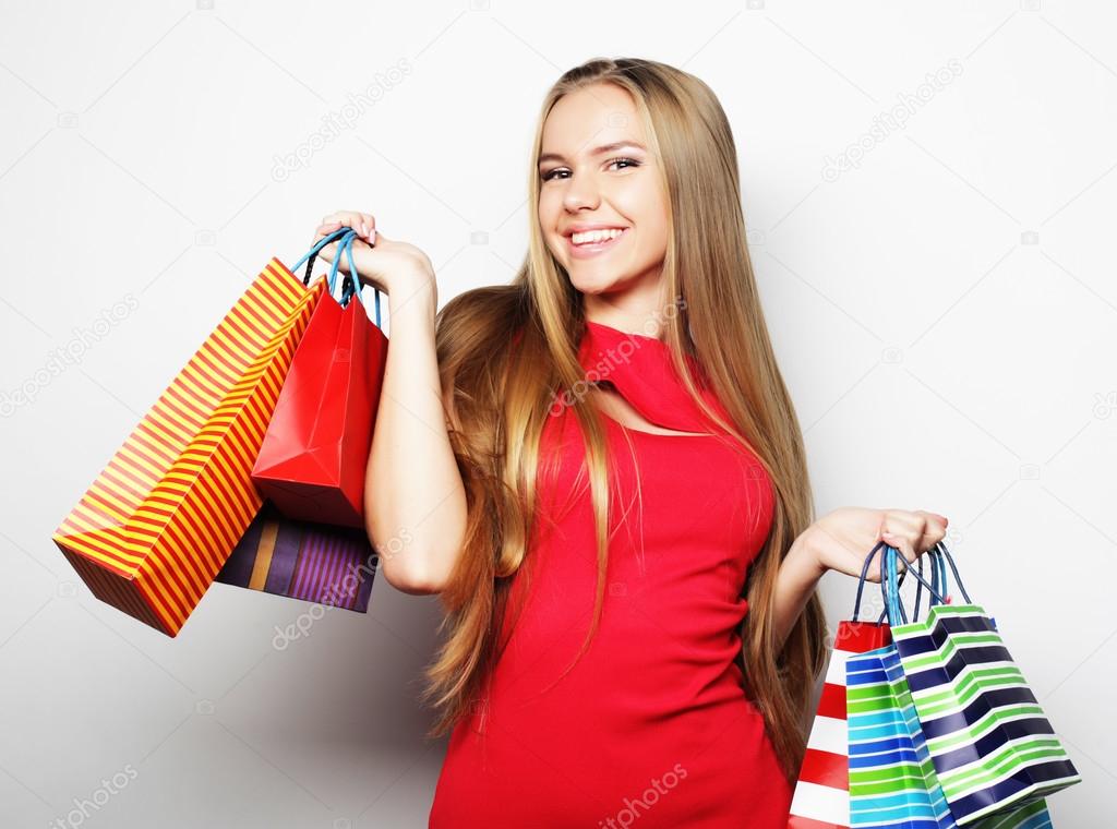 Portrait of young happy smiling woman with shopping bags