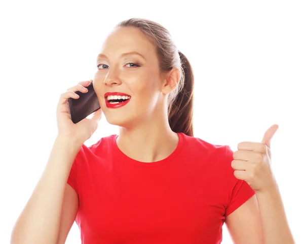 Woman using a mobile phone isolated on a white background — Stock Photo, Image