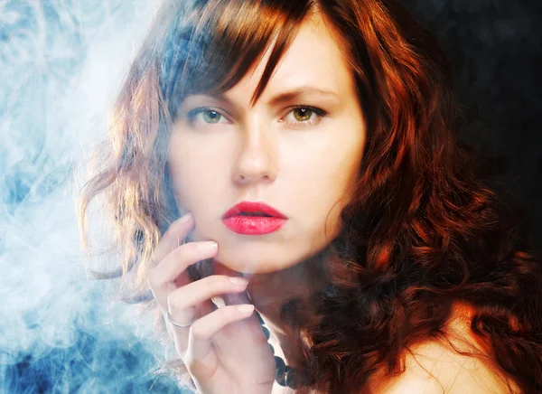 Young and sexy woman in smoke — Stock Photo, Image