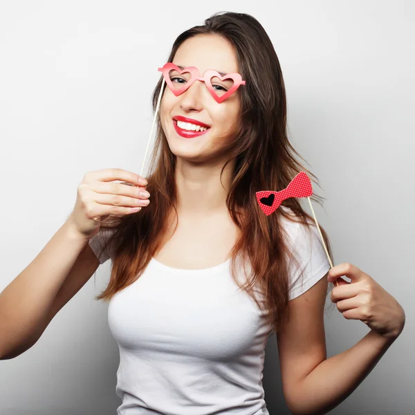 Party image. Playful young woman holding a party glasses. — Stock Photo, Image