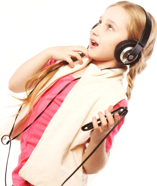 Dancing little girl headphones music singing on white background — Stock Photo, Image