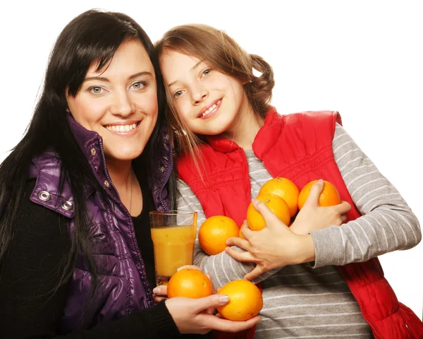 Child with mother holding oranges and juice — Stock Photo, Image