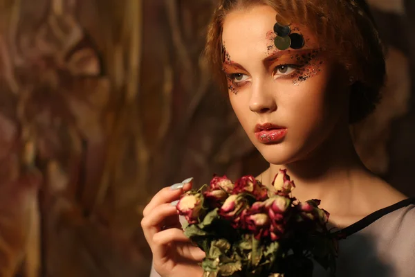 Beautiful girl with dry roses — Stock Photo, Image