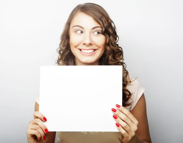 Smiling young casual style woman showing blank signboard Stock Photo