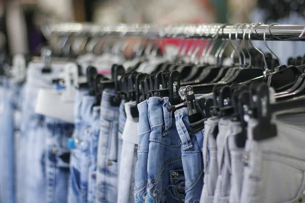 Row of hanged blue jeans — Stock Photo, Image