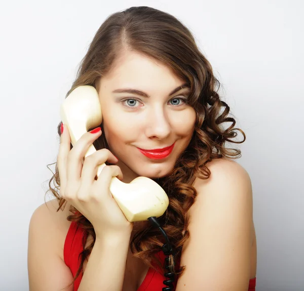 Beautiful curly woman  talking on white telephone — Stock Photo, Image